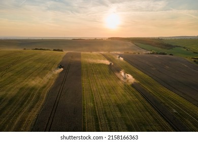 Aerial view of combine harvesters working during harvesting season on large ripe wheat field. Agriculture concept - Shutterstock ID 2158166363