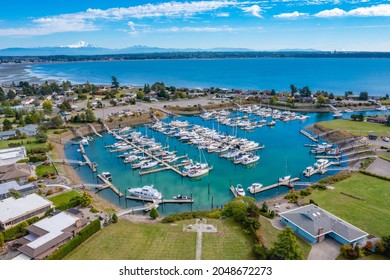 Aerial View Of A Community Of Homes With A Marina Golf Course And Ocean Views