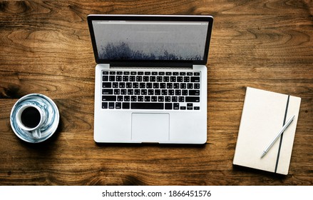 Aerial View Of Computer Laptop On Wooden Table Workspace Concept