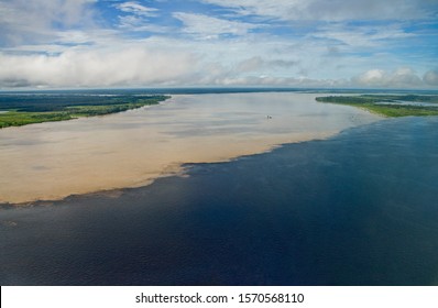 Aerial View Of The Confluence Of The Rio Negro's Water And The Solimoes River's Water