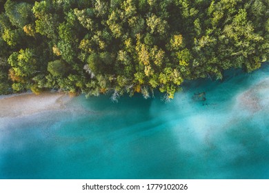 Aerial view coniferous forest and river drone landscape in Norway above trees and blue water scandinavian nature wilderness top down scenery 