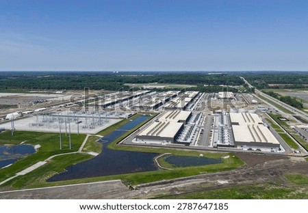 Aerial view of the construction of data center complex, large AI center structure surrounded by cooling and power back up systems