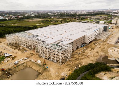 Aerial view of the construction site of a large distribution centre warehouse on the outskirts of a large city being built