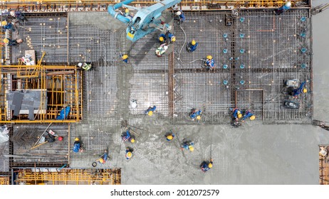 Aerial view construction worker pouring concrete by pumping - Shutterstock ID 2012072579
