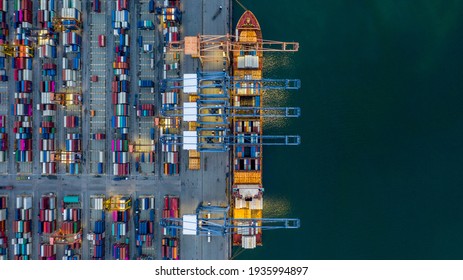 Aerial view container ship loaded in container terminal at night, Global business import export logistic and transportation, Commercial dock company cargo vessel freight shipping at night. - Shutterstock ID 1935994897
