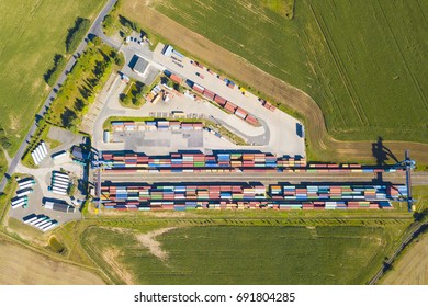 Aerial View Of Container Terminal On A Railway With Open Storage Area. Many Containers Before Transport From Drone View. Industrial Zone From Above In Landscape. Nyrany, Czech Republic, Central Europe