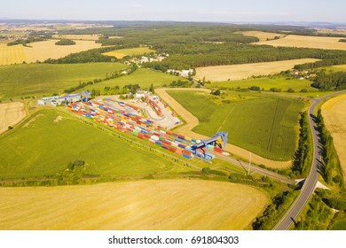 Aerial View Of Container Terminal On A Railway With Open Storage Area. Many Containers Before Transport From Drone View. Industrial Zone From Above In Landscape. Nyrany, Czech Republic, Central Europe