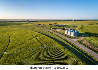 Aerial View Of Corn Field With Sprinkler, Silo, And Farm Buildings In Eastern Colorado