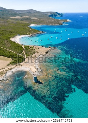 Aerial view of Corsica's step coastline and a lighthouse along the Sentier des Douaniers hiking trail