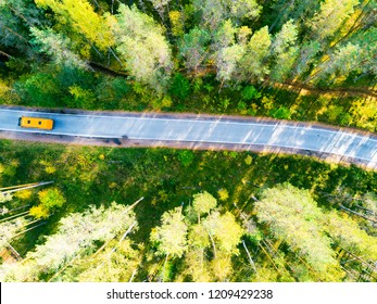 Aerial View Of A Country Road In The Forest With Moving Cars. Landscape. Captured From Above With A Drone. Aerial Bird's Eye Road With Car. Aerial Top View Forest. Texture Of Forest View From Above.