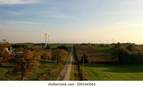 Aerial View Of A Country Road, Midwest Countryside In Fall Season. Rural Landscape. Sunset Sky, Sunlight, Harvest Season, Autumn, October