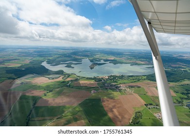 Aerial view of the countryside and a lake from a microlight in flight