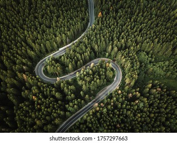 Aerial view of countryside road passing through the green forest and mountain - Shutterstock ID 1757297663