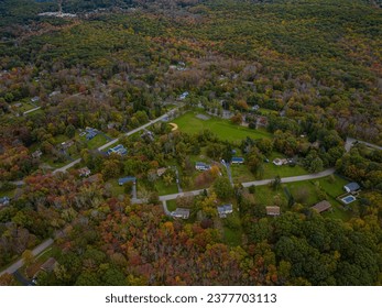 Aerial view of the countryside in Stormville, New York on a cloudy day during the colorful autumn season.