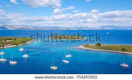 Aerial view of cozy mediterranean island. Blue lagoon, island paradise. Adriatic Sea of Croatia, popular touristic destination. Clear sea water.