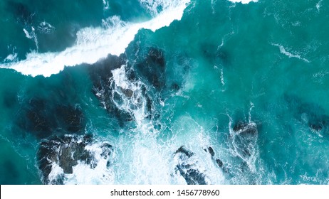 Aerial view of crashing waves on rocks. Aerial view of sea waves and fantastic Rocky coast,Background texture of a rocky shore and blue and turquoise water and waves of the Atlantic Ocean New Zealand. - Powered by Shutterstock