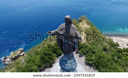 Aerial view of Cristo Rei statue of Jesus Christ with turquoise ocean water in the capital city Dili, Timor-Leste, Southeast Asia