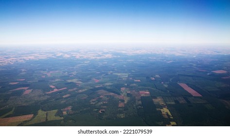 Aerial view of the cropland, farms and plantations from an airplane. 