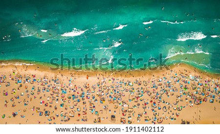 Similar – Luftaufnahme von fliegenden Drohnen von Menschen, die sich am Algarve Beach in Portugal entspannen.