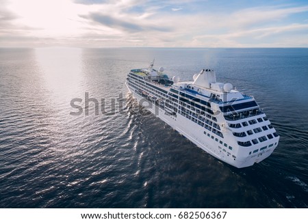 Aerial view of cruise liner sailing in the open sea at sunset