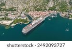 Aerial view of a cruise ship from the Holland America Line docked in Kotor, one of the most populars port of calls of the Mediterranean Sea located at the end of a fjord in Montenegro