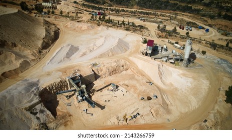 Aerial view of crushed stone quarry machine. Producing of construction materials at open pit limestone mine. Stone crushing plant. Cone type rock crusher - Shutterstock ID 2143266759