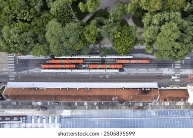 Aerial view of Curitiba, Brazil, and its buses and tube stops, and a verdant green park - Powered by Shutterstock