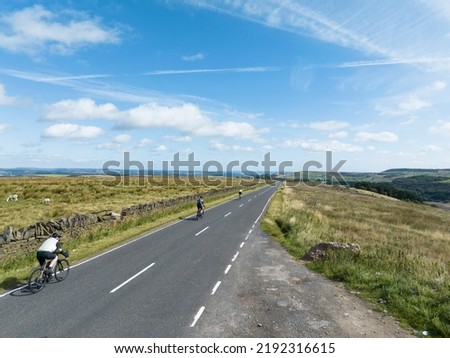 Aerial view of cyclists on the Scammonden Road at Moselden Height heading towards Scammonden Bridge, West Yorkshire