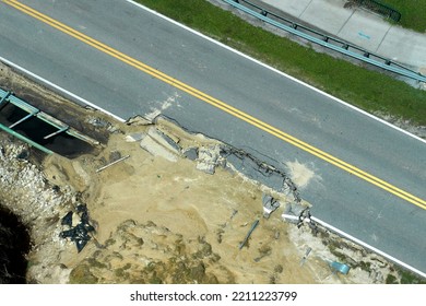 Aerial View Of Damaged Road After Flood Water Washed Away Asphalt. Rebuilding Of Ruined Transportation Infrastructure