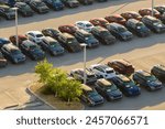 Aerial view of dealership parking lot with many brand new cars for sale. Development of american automotive industry concept
