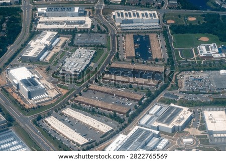 Aerial view of a dense cluster of data centers, including facilities under construction, in Loudoun County's Data Center Alley in Northern Virginia