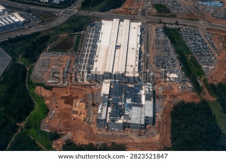 Aerial view of a dense cluster of data centers, including facilities under construction, in Loudoun County's Data Center Alley in Northern Virginia