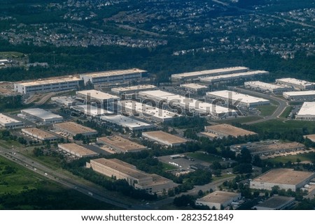 Aerial view of a dense cluster of data centers, including facilities under construction, in Loudoun County's Data Center Alley in Northern Virginia