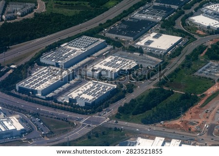 Aerial view of a dense cluster of data centers, including facilities under construction, in Loudoun County's Data Center Alley in Northern Virginia