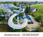 Aerial View of Deserted Water Park with Blue Loop Slide and Overcast Sky