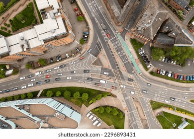 Aerial view directly above a complex road junction or intersection with traffic travelling in different directions - Powered by Shutterstock