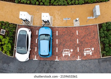 An Aerial View Directly Above Electric Cars Being Charged At A Motorway Service Station Car Charging Station