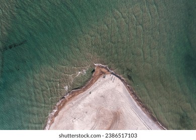 Aerial view directly above the Grenen - a meeting point of North and Baltic Sea on Skagen Odde peninsula. North Jutland, Nordjylland, Denmark