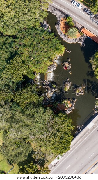 An aerial view\
directly above man-made waterfalls at the entrance of an apartment\
complex in Lauderdale Lakes, Florida. The drone camera is looking\
straight down on a sunny\
day.