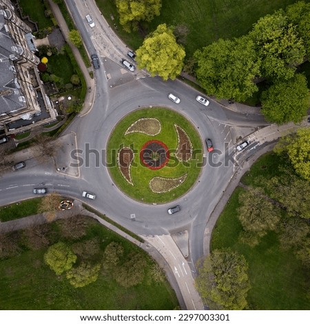 Aerial view directly above a road roundabout in Harrogate, North Yorkshire with landscaped flower beds during the Spring Floral Trail