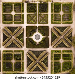 Aerial view directly above rows of landscaped flower beds in an English formal garden with water features - Powered by Shutterstock