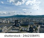 Aerial view of District Altstetten with skyscrapers and local mountain Uetliberg in the background at Swiss City of Zürich on a sunny spring afternoon. Photo taken May 14th, 2024, Zurich, Switzerland.