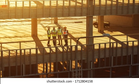 Aerial View: Diverse Team of Specialists Inspect Commercial, Industrial Building / Skyscraper Formwork Construction Site. Real Estate Project Lead by Civil Engineer, Investor, Architect and Worker