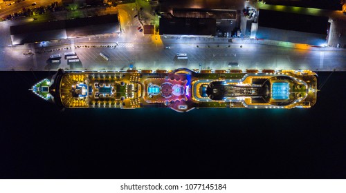 Aerial View Of A Docked Cruise Ship At Night.