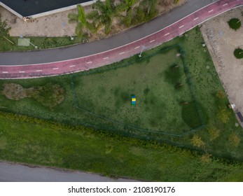 Aerial View Of Dog Place In Ilha Pura Park At Sunset. Coconut Trees, Water Mirror And Running Track Next Door. Rio De Janeiro, Brazil. Sunny Day. Top View. Drone Take.