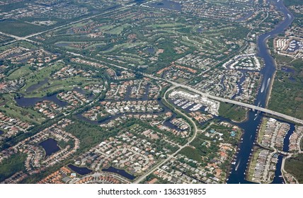 Aerial View Of The Donald Ross Bridge In Juno Beach, Florida, With Upscale Golf Courses And Gated Communities.