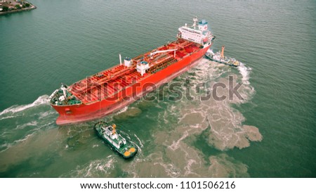 Aerial view of Dorn Tug boats pull the newly refurbished tanker out of the shipyard.