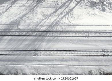 Aerial View Of A Double-track Railway After Heavy Snowfall. Winter Rail Road With White Snow, Top View. Transport Infrastructure, Train Track, Snowy Landscape