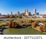 Aerial view of the downtown cityscape and fall color of Veterans Park at Tulsa, Oklahoma