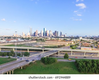 Aerial view downtown and interstate 10 highway (Katy freeway). Suburbs area, factory/warehouse, stack interchange and elevated road junction overpass at sunset from northwest side of Houston, Texas,US